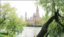  ??  ?? A view of Zaragoza’s Basilica del Pilar from the banks of the River Ebro. Tree-lined paths
make the riverside a pleasant place for a stroll. (AP)