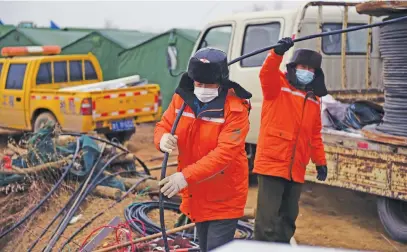 ?? Picture: AFP ?? GETTING IT DONE. Members of a rescue team work at the site of a gold mine explosion, where 22 miners were trapped undergroun­d in Qixia, in eastern China’s Shandong province.