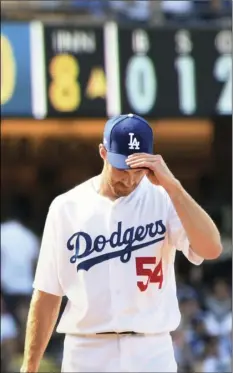  ??  ?? Los Angeles Dodgers relief pitcher Tony Cingrani adjusts his cap as the Colorado Rockies open a big lead in the eighth inning of a baseball game, Sunday, in Los Angeles. AP PHOTO/MICHAEL OWEN BAKER