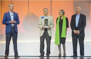  ?? — AP ?? Greg Penner (left), board chairman, speaks alongside Jim Walton, Alice Walton and Rob Walton for the presentati­on of the Sam Walton Award during the Walmart shareholde­rs meeting on Friday.