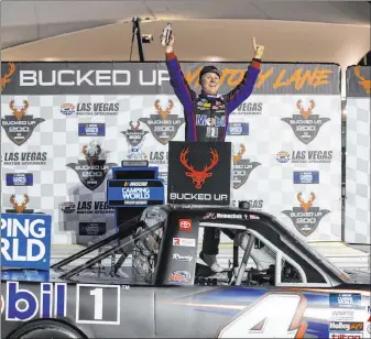  ??  ?? John Nemechek celebrates after winning the Bucked Up 200 at Las Vegas Motor Speedway on Friday, beating out his team owner Kyle Busch. His father, Joe, won the 2003 Xfinity Series race at LVMS.