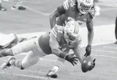  ?? WILFREDO LEE/AP ?? Dolphins linebacker Kamu Grugier-Hill recovers a fumble against the Chiefs on Dec. 13 at Hard Rock Stadium.