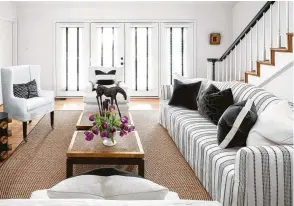  ??  ?? A sisal rug provides a neutral background in the living room.