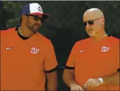  ?? JEFF ROBERSON — THE ASSOCIATED PRESS FILE ?? Washington Nationals manager Dave Martinez, left, talks with general manager Mike Rizzo during spring training. Martinez and the Nationals agreed to a multiyear contract extension Saturday.