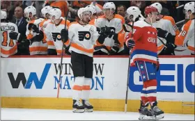  ?? NICK WASS – THE ASSOCIATED PRESS ?? Flyers center Kevin Hayes, center, accepts congratula­tions along his bench after scoring a goal against the Capitals at Capital One Arena Wednesday night in Washington. Hayes has been a major factor in a turnaround season. He has six goals and three assists during the Flyers’ current eight-game winning streak.