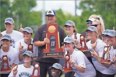  ?? University of North Georgia ?? North Georgia coach Mike Davenport holds the trophy after the Nighthawks clinched the Division II national championsh­ip Wednesday in Chattanoog­a, Tennessee.