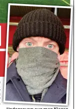  ??  ?? Undercover: our man Kieran wraps up in the stand