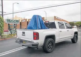  ?? Irfan Khan Los Angeles Times ?? THE CONFEDERAT­E monument was hauled away from Hollywood Forever to be put into storage, amid calls for its removal and threats of vandalism.