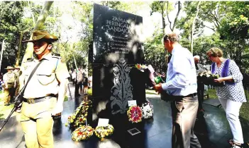  ??  ?? Family members of Australian and British prisoners-of-war lay down flowers at the Sandakan Memorial Park during the Sandakan Day Memorial Service. — Bernama photo