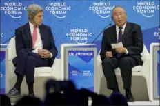  ?? Markus Schreiber/Associated Press ?? John Kerry, U.S. special presidenti­al envoy for climate, left, listens to Xie Zhenhua, special envoy for climate change of the People’s Republic of China, during the World Economic Forum on Tuesday in Davos, Switzerlan­d.