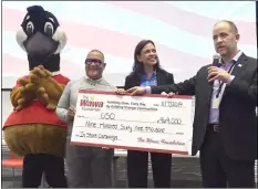  ?? PETE BANNAN - MEDIANEWS GROUP ?? USO Accounts Manager Kirk Parker and USO Executive Director Jo Anne Schultze accept a check from Wawa Director of Operations Jim Lee for over $960,000 from the Wawa Foundation and donations from customers.