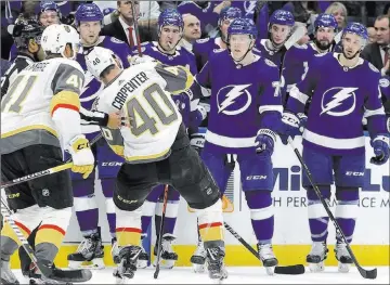 ?? Chris O’meara The Associated Press ?? A wobbly Ryan Carpenter is helped off the ice Tuesday night after being hit by Tampa Bay Lightning center Cedric Paquette during the second period of the Golden Knights’ 3-2 shootout victory.