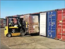  ?? KATHLEEN CAREY - DIGITAL FIRST MEDIA ?? Penn Terminals employee Jose Martinez loads material into boxcars that will head to hurricane-ravaged areas of Puerto Rico. He says it helps to work as he waits for any word from his family on the battered island.
