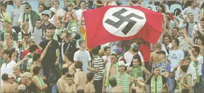  ?? PHOTO: REUTERS ?? Supporters of Karpaty Lviv football team hold a Nazi flag during a match against Dynamo Kiev