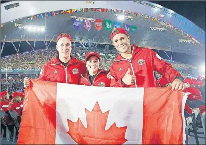  ?? PHOTO BY MATHIEU BÉLANGER ?? Cape Breton University soccer stars Ian Greedy, Karolyne Blain and Justin Maheu show off their Canadian pride at the opening ceremonies of Universiad­e 2015 in Gwangju, South Korea. CBU women’s basketball coach Fabian McKenzie is also at the games as...