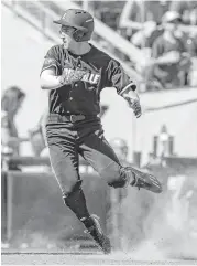  ?? Nati Harnik / Associated Press ?? Pinch runner Ryan Summers was practicall­y clicking his heels after scoring Louisville’s final run on an eighth-inning single by Colby Fitch.