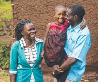  ??  ?? GRATEFUL: Night Baeni enjoys a cuddle with her parents Deborah and Stephen Baeni after her procedure. Picture: Contribute­d