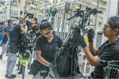  ?? ATUL LOKE/THE NEW YORK TIMES ?? Workers build scooters Aug. 24 at an Ola Electric factory in the southern Indian state of Tamil Nadu.