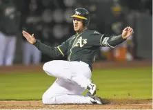  ?? Thearon W. Henderson / Getty Images ?? Stephen Piscotty scores on a fourth-inning sacrifice fly by Jonathan Lucroy. Oakland banged out 12 hits in a 10-1 win.