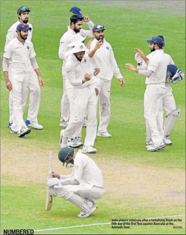  ?? REUTERS ?? India players celebrate after a tantalisin­g finish on the fifth day of the first Test against Australia at the Adelaide Oval.