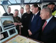  ??  ?? Defence Minister Paul Kehoe and Regional Economic Developmen­t Minister and local TD Michael Ring are debriefed from the bridge of the LE Samuel Beckett situated near Blacksod Bay in Co Mayo. Photo: Steve Humphreys