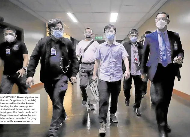  ?? —SENATE PRIB PHOTO ?? IN CUSTODY Pharmally director Linconn Ong (fourth from left) is escorted inside the Senate building for the resumption of the blue ribbon committee hearing on the firm’s deals with the government, where he was later ordered arrested for lying under oath.