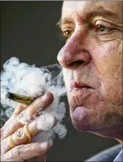  ?? BRUCE R. BENNETT / THE PALM BEACH POST ?? Boca Raton stockbroke­r Irvin Rosenfeld smokes a government-supplied medical marijuana cigarette. He said the marijuana has never made him high, even when, as a teen, he smoked it illegally.