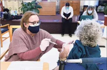  ?? Arnold Gold / Hearst Connecticu­t Media ?? Retired Army nurses Maggie Nuzzelillo, above left, and John Grimes, below, administer the Moderna COVID-19 vaccine to Mary Connelly, 93, of Clinton, and Maryann Cappelli, of East Haven, respective­ly, at the East Haven Senior Center on Friday.