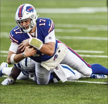  ?? THE ASSOCIATED PRESS ?? Bills quarterbac­k Josh Allen (17) is tackled by Colts’ Kenny Moore II during the first round of the playoffs Saturday.