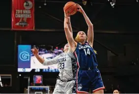  ?? Terrance Williams/Associated Press ?? UConn’s Dorka Juhasz grabs a rebound over Georgetown’s Graceann Bennett. The Huskies went on to win to snap their two-game losing streak.