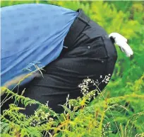  ?? PHOTOS: RAMSEY CARDEY/GERRY MOONEY ?? A day to forget: Rory McIlroy hunts for his ball on the first hole at Portrush; bottom left, Rory at the 17th; below, Rory’s wife Erica McIlroy; bottom, US fans Carter Briggs, Mike Huffman, Michael O’Connor and Mike Huffman Jnr.