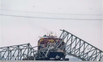  ?? — AFP ?? The collapsed Francis Scott Key Bridge lies on top of the container ship Dali in Baltimore, Maryland.