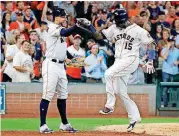  ?? [AP PHOTO] ?? Houston Astros’ Martin Maldonado, right, celebrates his solo home run against the Cleveland Indians with teammate George Springer during the seventh inning in Game 1 of an American League Division Series on Friday in Houston.