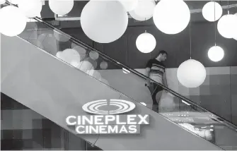  ?? NATHAN DENETTE, CP ?? A moviegoer makes his way down an escalator at a Cineplex theatre in Toronto.