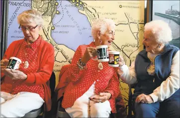  ?? PHOTOS BY HALEY NELSON ?? Marian Sousa, 92, left, inspects her newly gifted mug as Kay Morrison, 94, and Josephine Lico, 103, say cheers at the National Rosie the Riveter Day celebratio­n at the Rosie the Riveter Visitor Education Center in Richmond.