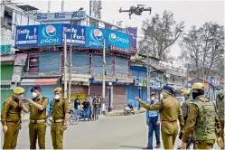  ?? — PTI ?? Police uses drone to keep a check in the interior areas, during restrictio­ns imposed as a precaution­ary measure to contain the spread of coronaviru­s, in Srinagar on Monday.