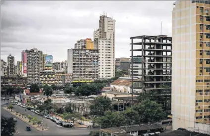  ??  ?? City of contrasts: Maputo has a slightly rundown feel to it, but there is plenty of constructi­on work going on, including the Maputo-Catembe Bridge, which will be the longest suspension bridge in Africa once completed. Photos: Gianluigi Guercia/AFP &...
