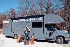  ??  ?? Lee Asher and his adopted shelter dogs are shown outside the RV they’re using for their cross-country trip.