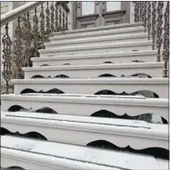  ??  ?? Elements of the cast-iron banister on the front stairs were fabricated in Spain.