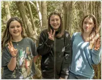  ?? JUAN ZARAMA PERINI/STUFF ?? From left: Mākara Model School Year 8 students Billie Kyle, Charlotte Robinson, and Elena Reid, all 13, look forward to having kiwi roaming the surroundin­g foothills.