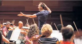  ??  ?? English conductor Andrew Gourlay leads Auckland Philharmon­ia Orchestra’s Defiance programme.