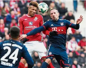  ??  ?? Heads up: Mainz’s Jean Philippe Gbamin (left) and Bayern Munich’s Franck Ribery vying for the ball in the Bundesliga match in Mainz on Saturday. — AFP