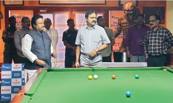  ??  ?? Member of Parliament A.P. Jitender Reddy (left) and president of the Billiards &amp; Snooker Federation of India Capt. PVK Mohan (centre) play during the inaugurati­on of the Telangana State Ranking Snooker &amp; Billiards Championsh­ip at the Film Nagar Cultural Centre in Jubilee Hills, Hyderabad, on Thursday.