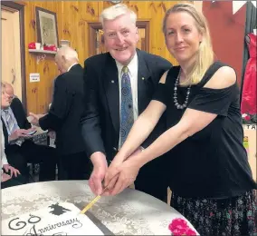  ??  ?? CELEBRATIO­N: Tony Lamb and his daughter Emma cut a cake marking the 60th anniversar­y of the Horsham hall named in honour of their father and grandfathe­r.