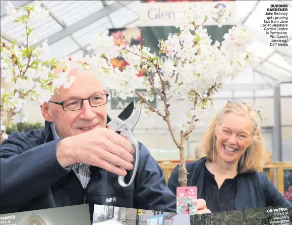  ??  ?? BUDDING GARDENER John Swinney gets pruning tips from Jane Cox at Glendoick Garden Centre in Perthshire. Pic: Gareth Jennings/ DCT Media