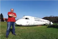 ??  ?? Croatian citizen Robert Sedlar poses in front of a former SunAdria Holland Fokker-100 aircraft in his garden. — AFP photos