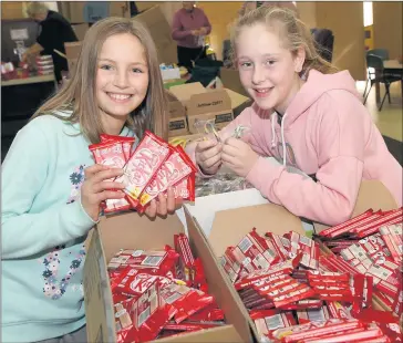  ??  ?? TREATS: Stephanie Wundke and Asha Fielder help pack goodie bags for Horsham combined churches’ Operation 19:14 family-fun day on Sunday. Picture: PAUL CARRACHER