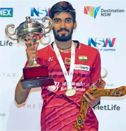  ?? AFP ?? Kidambi Srikanth poses with the trophy after defeating Chen Long in the Australian Open badminton final in Sydney on Sunday. —