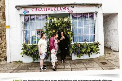  ??  ?? ABOVE Local business dress their doors and windows with celebrator­y garlands of flowers