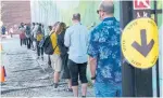  ?? PAUL CHIASSON THE CANADIAN PRESS ?? People line up in a school yard to cast their vote at a polling station in Montreal.